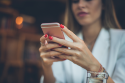mulher usando celular para escolher o melhor banco digital