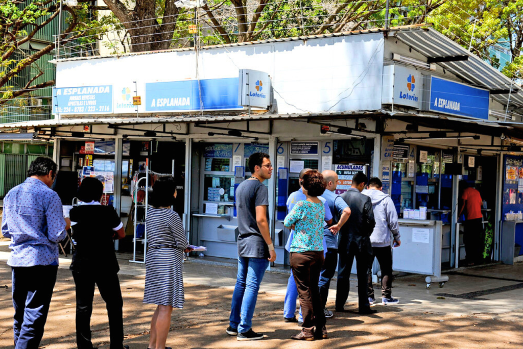 Fila de clientes em frente a uma casa lotérica durante o horário de funcionamento