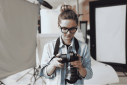 mulher com câmera na mão para representar Quanto ganha um fotógrafo
